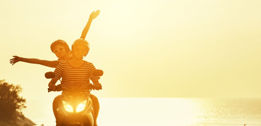 Two friends enjoying a motorcycle ride at sunset.