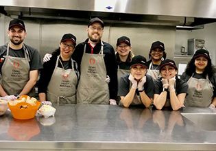 Patelco team members in the kitchen gettting ready to serve at Open Heart Kitchen